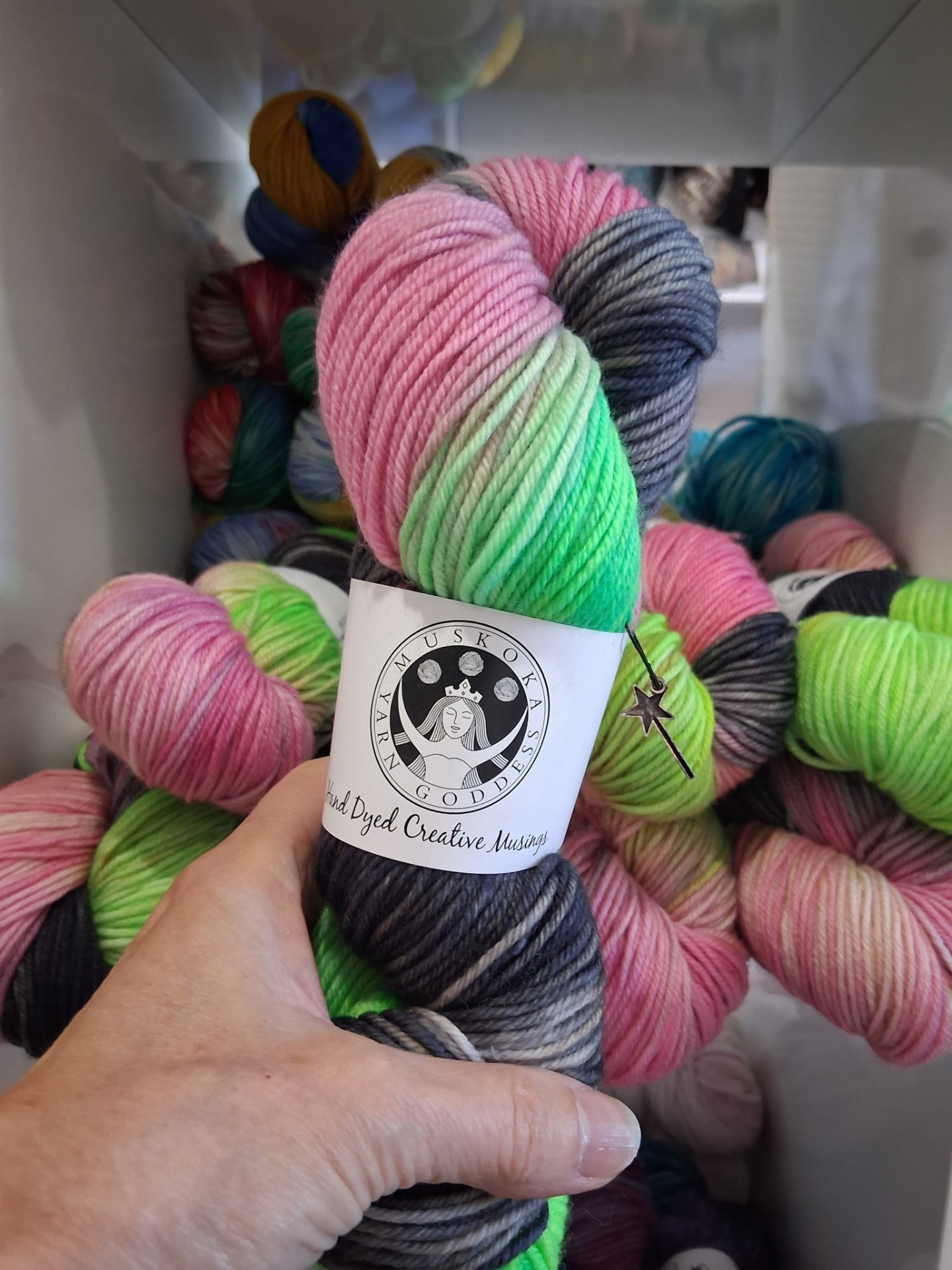 A stack of hand-dyed sock yarn in warm and cool shades